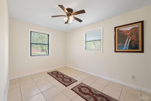 702 Beauvais Rd, Pensacola, FL 32505 - spare room with ceiling fan, light tile patterned floors, baseboards, and a wealth of natural light
