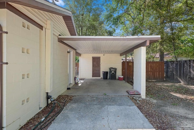 702 Beauvais Rd, Pensacola, FL 32505 - view of vehicle parking with fence, an attached carport, and driveway