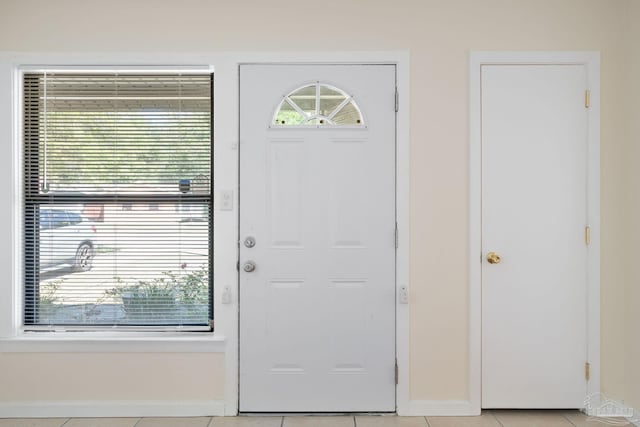 702 Beauvais Rd, Pensacola, FL 32505 - doorway with baseboards and light tile patterned flooring