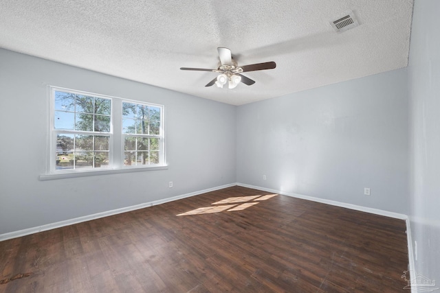 unfurnished room featuring a textured ceiling, dark hardwood / wood-style floors, and ceiling fan