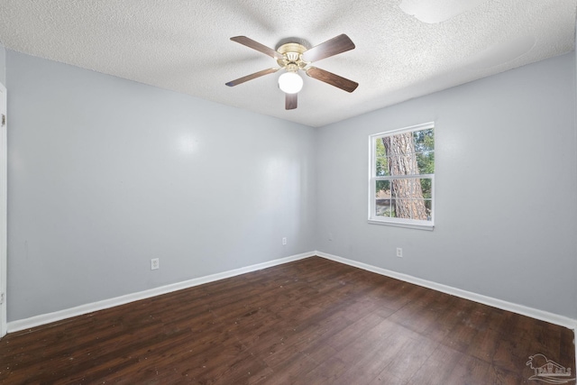 empty room with ceiling fan, dark hardwood / wood-style flooring, and a textured ceiling