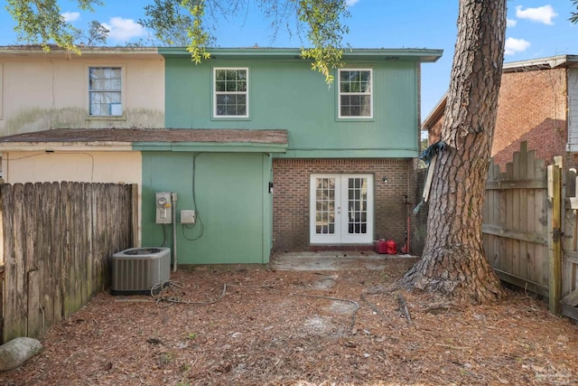 back of house with central AC unit and french doors