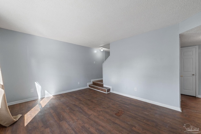 unfurnished living room featuring dark hardwood / wood-style floors and a textured ceiling