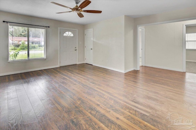 foyer featuring dark wood-type flooring and ceiling fan