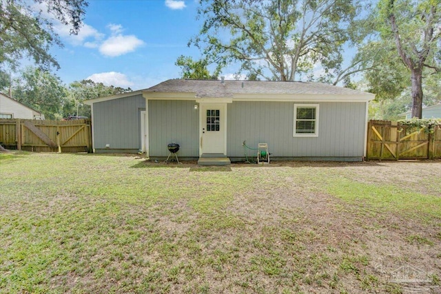 rear view of house with a lawn