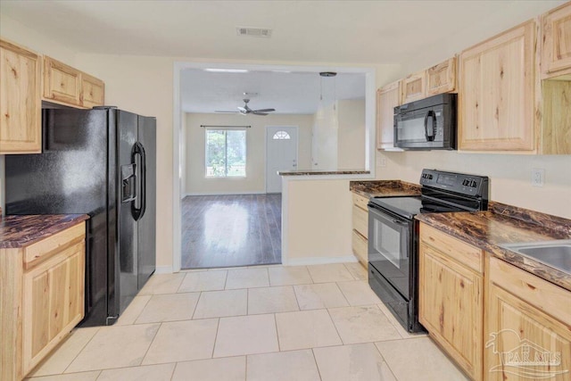 kitchen with pendant lighting, light brown cabinets, and black appliances