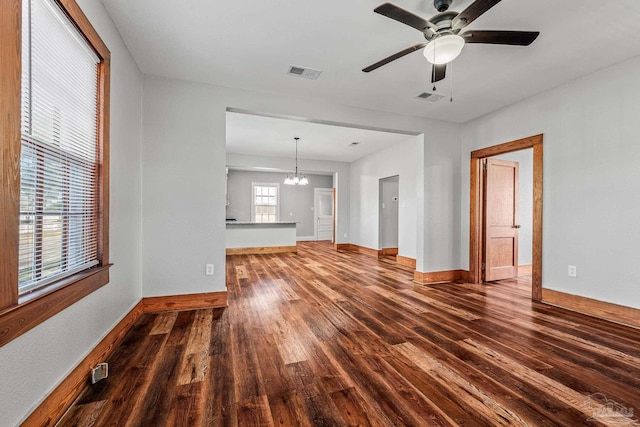 unfurnished living room with visible vents, baseboards, and wood finished floors