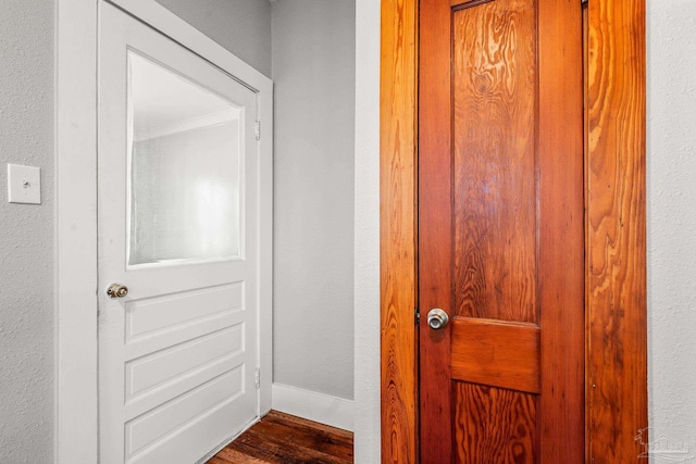 room details featuring a textured wall and baseboards