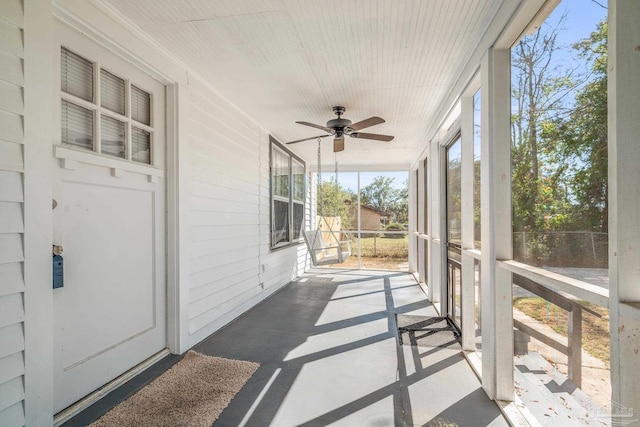 sunroom / solarium with a ceiling fan