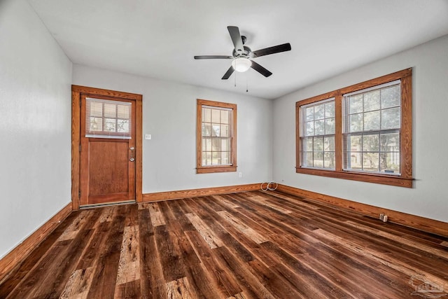 foyer with ceiling fan, dark wood-style flooring, and baseboards