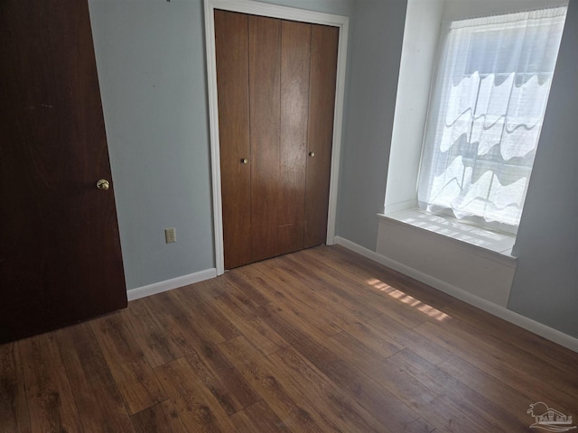 3285 Fairview Dr, Crestview, FL 32539 - unfurnished bedroom with dark wood finished floors, baseboards, and a closet