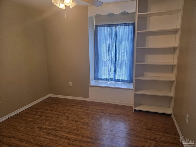 3285 Fairview Dr, Crestview, FL 32539 - unfurnished bedroom with baseboards and dark wood-style flooring