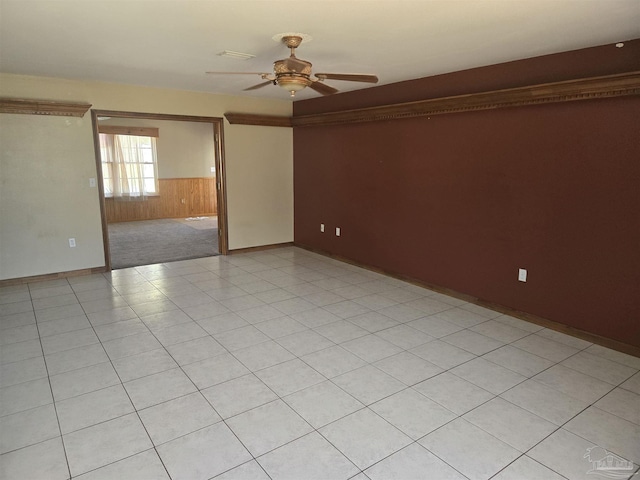 3285 Fairview Dr, Crestview, FL 32539 - empty room featuring light tile patterned flooring, wood walls, and ceiling fan