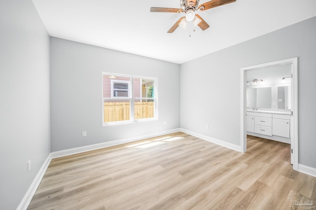 unfurnished bedroom with ensuite bath, ceiling fan, and light wood-type flooring