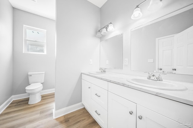 bathroom featuring vanity, toilet, and hardwood / wood-style floors