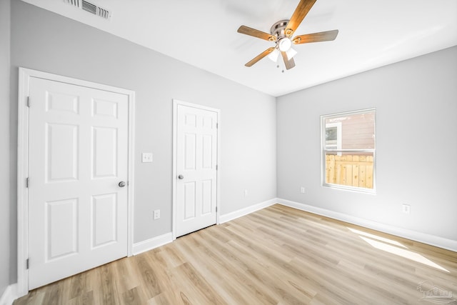 unfurnished bedroom with ceiling fan and light hardwood / wood-style floors