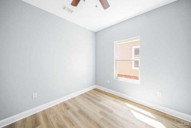 spare room with ceiling fan and light wood-type flooring