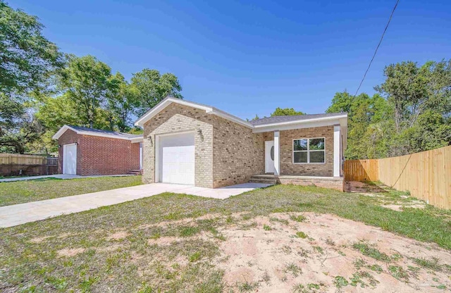 single story home featuring a garage and a front yard