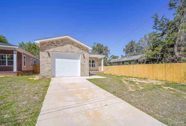 view of front of house with a garage and a front yard