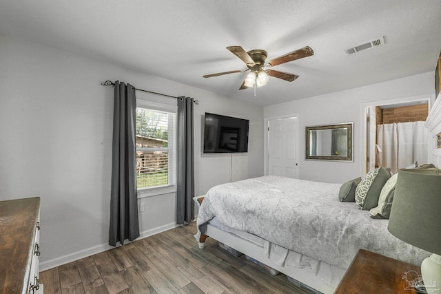 bedroom featuring dark hardwood / wood-style flooring and ceiling fan