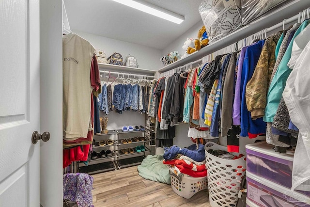 spacious closet with light hardwood / wood-style flooring