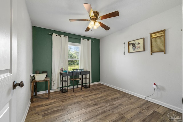 interior space featuring ceiling fan and dark hardwood / wood-style floors