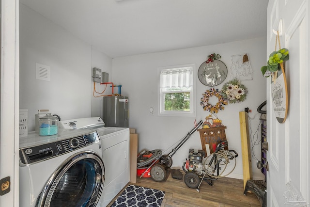 laundry room with hardwood / wood-style flooring, independent washer and dryer, and water heater