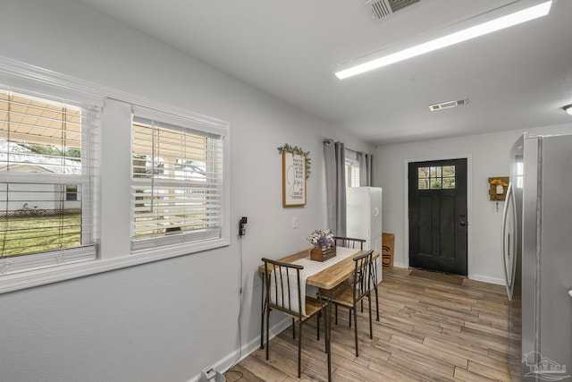 foyer entrance with hardwood / wood-style floors and a wealth of natural light