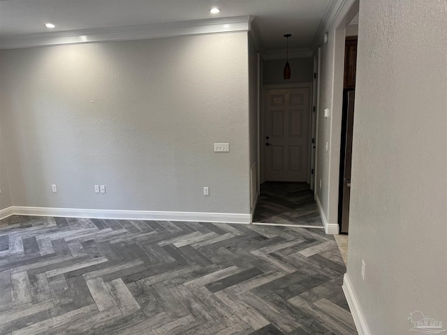 spare room with dark parquet flooring and ornamental molding