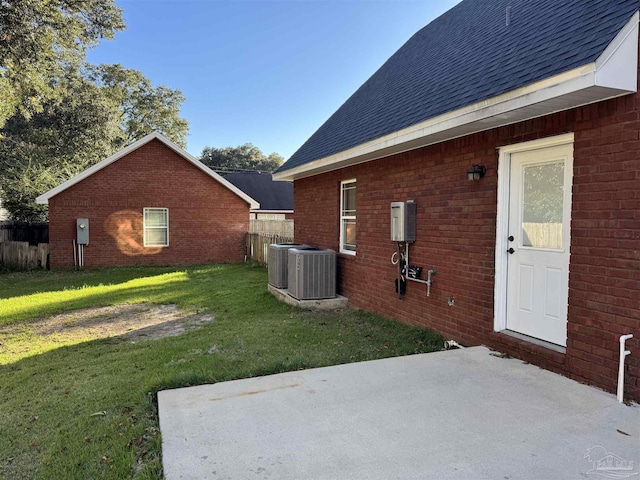 view of yard featuring central air condition unit and a patio