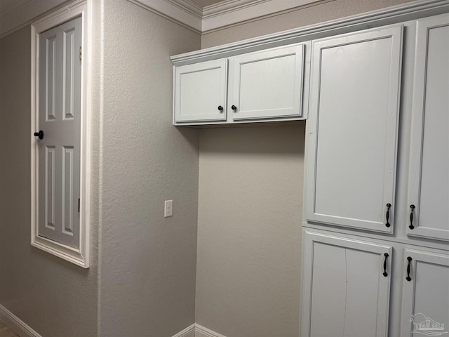 laundry area with ornamental molding