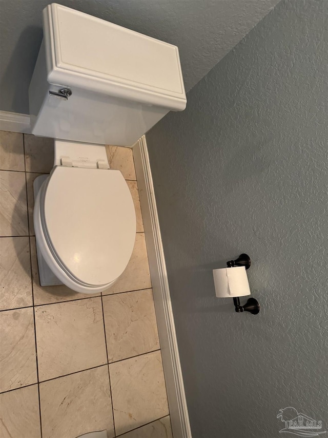 bathroom featuring tile patterned flooring and lofted ceiling