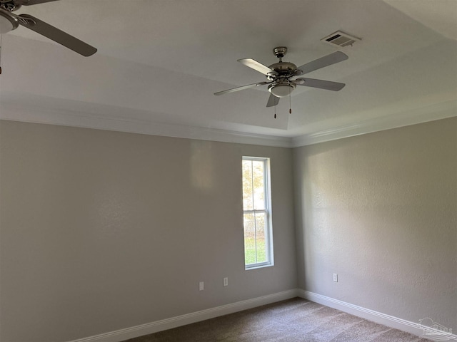 empty room with ceiling fan, carpet floors, and ornamental molding