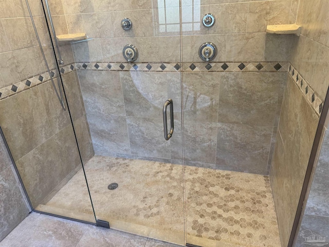 bathroom featuring a shower with door