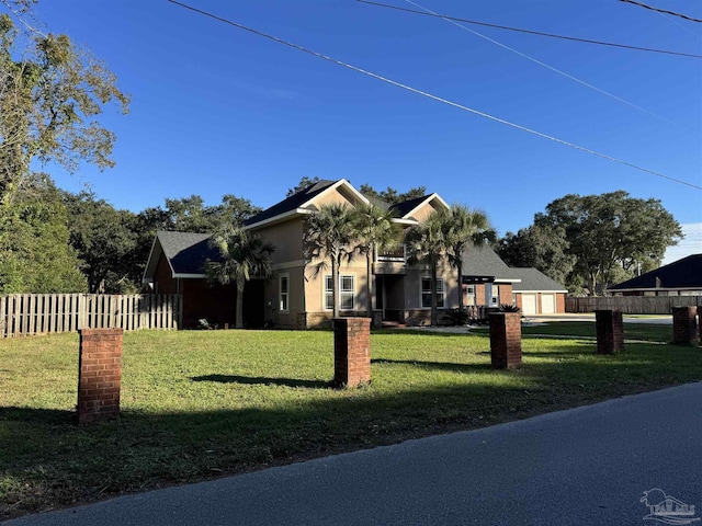 view of front of house with a front yard and a garage