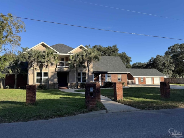 view of front of house with a balcony and a front yard