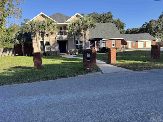 view of front facade with a balcony and a front lawn