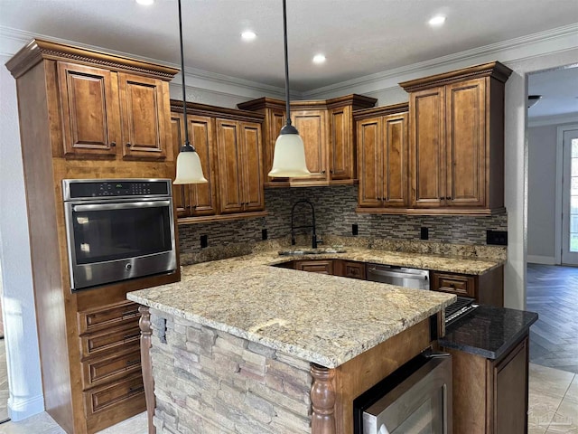 kitchen featuring decorative light fixtures, a kitchen island, ornamental molding, and appliances with stainless steel finishes