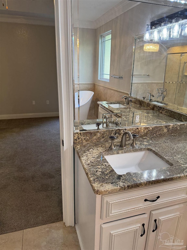 bathroom with vanity, ornamental molding, and a tub