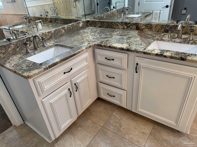 bathroom with tile patterned floors and vanity