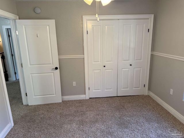 unfurnished bedroom featuring carpet flooring and a closet