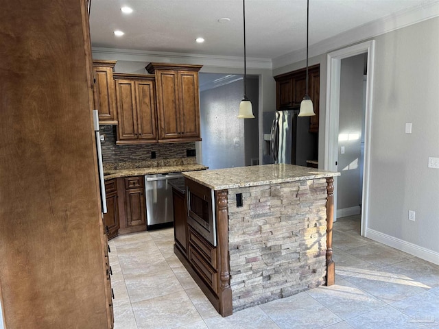 kitchen with tasteful backsplash, light stone counters, pendant lighting, a kitchen island, and appliances with stainless steel finishes