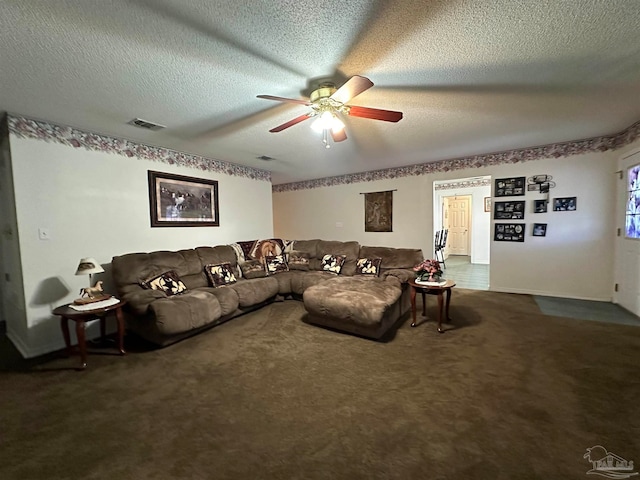 carpeted living room with a textured ceiling and ceiling fan