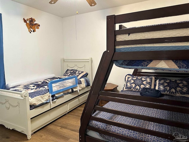 bedroom featuring ceiling fan and hardwood / wood-style flooring