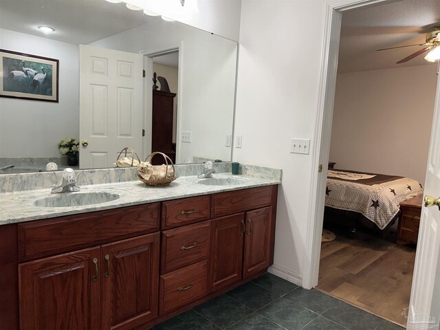 bathroom with wood-type flooring, dual vanity, and ceiling fan