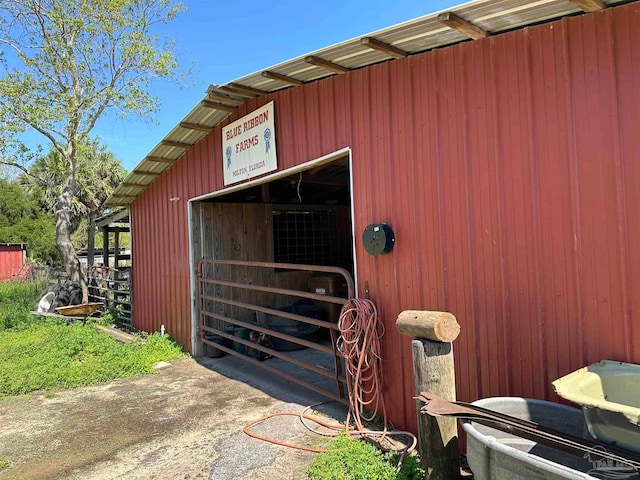 view of horse barn with an outbuilding