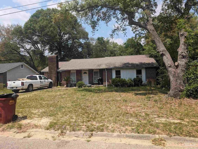 single story home with brick siding and a front lawn