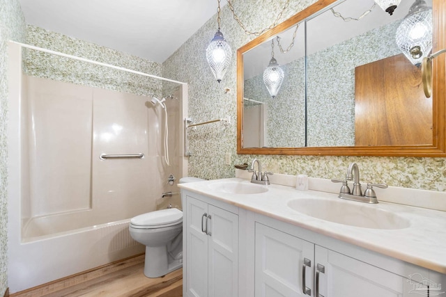 full bathroom with wood-type flooring, vanity, toilet, and tiled shower / bath