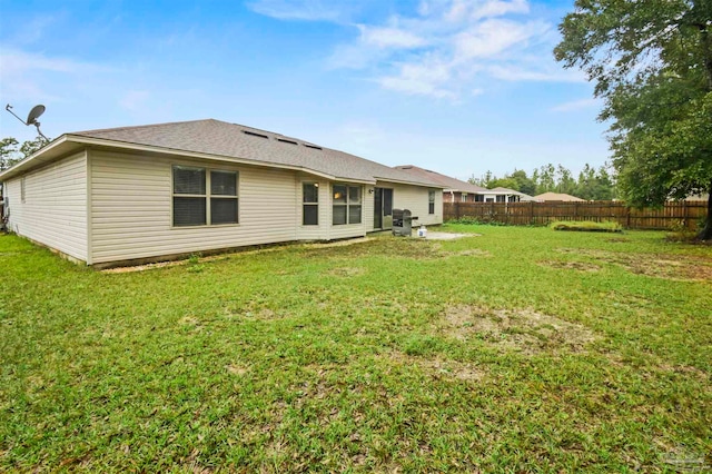 rear view of property with a yard