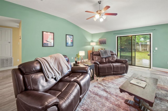 living room featuring ceiling fan, light hardwood / wood-style flooring, and vaulted ceiling